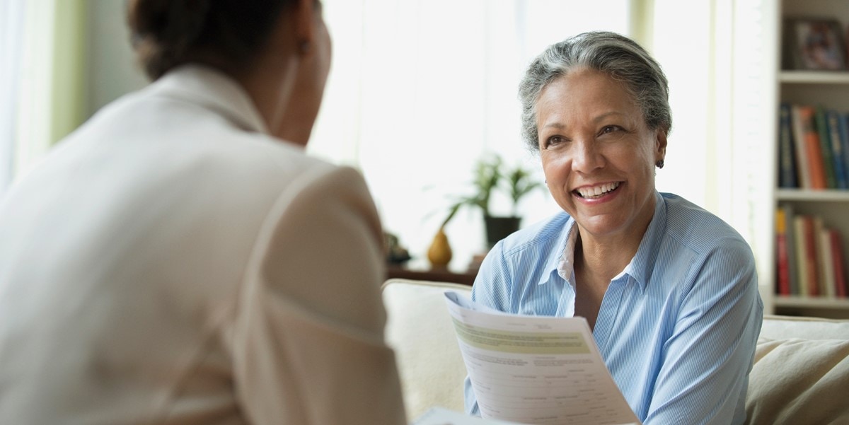 woman in office with document in hand