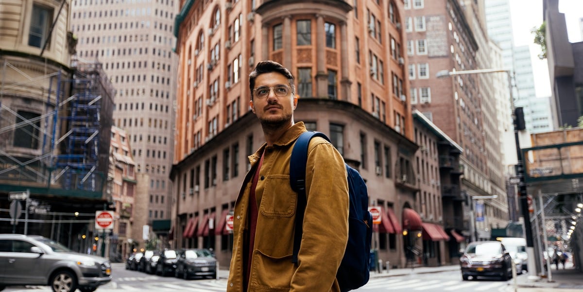 traveler standing outside, in front of building