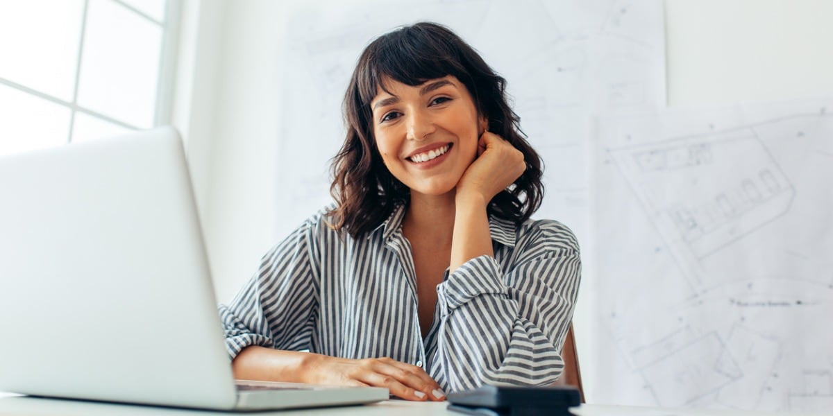 woman smiling with computer