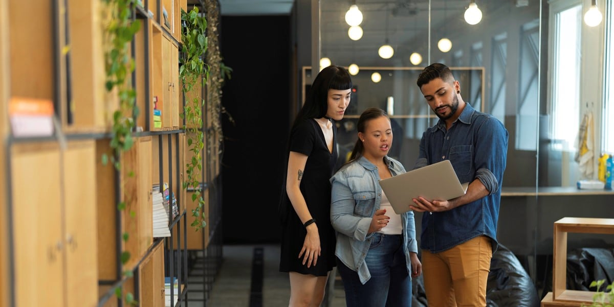 3 people in office looking at document