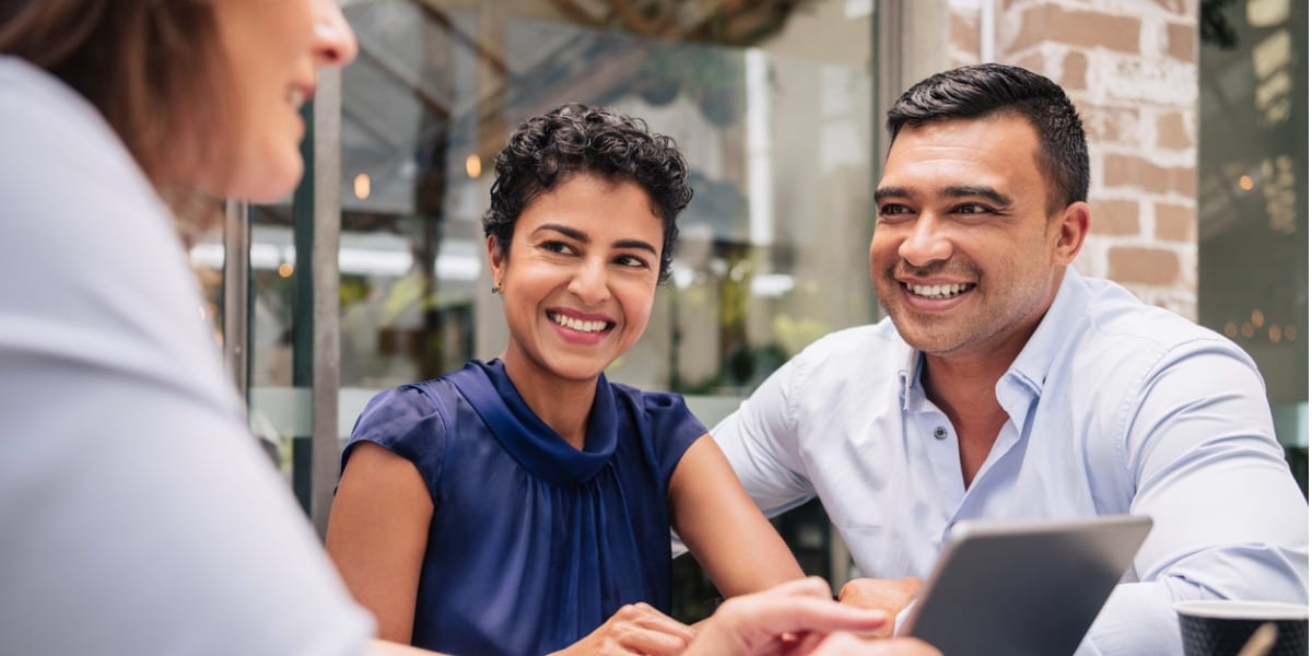 people conversing and smiling