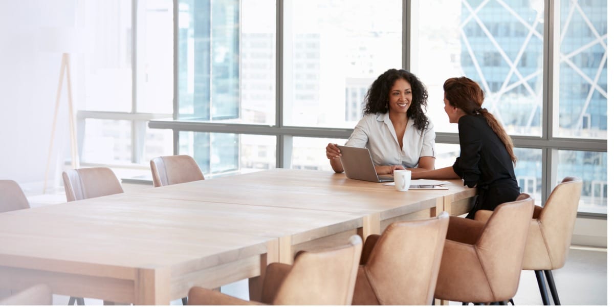 two women boardroom meeting