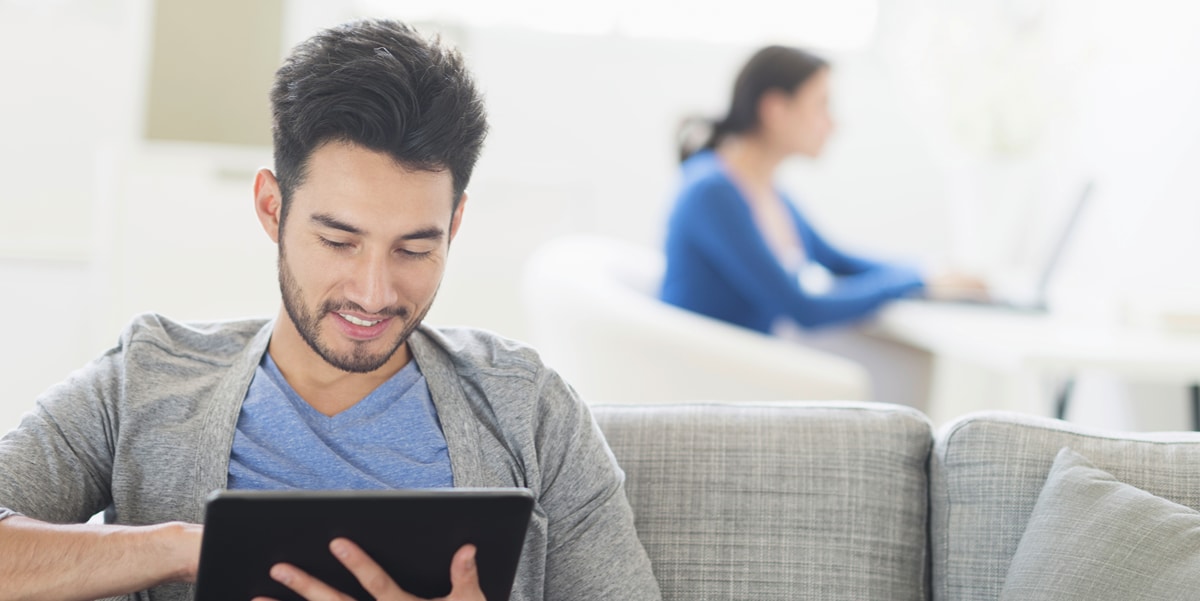 man on a coach using a tablet