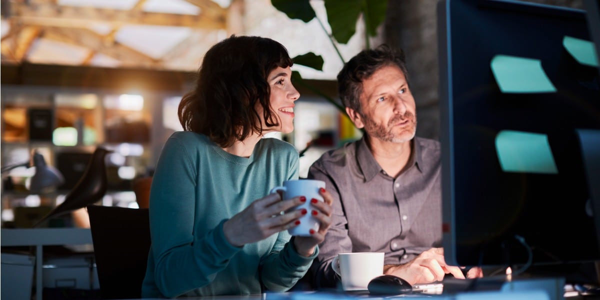 two people working on a laptop