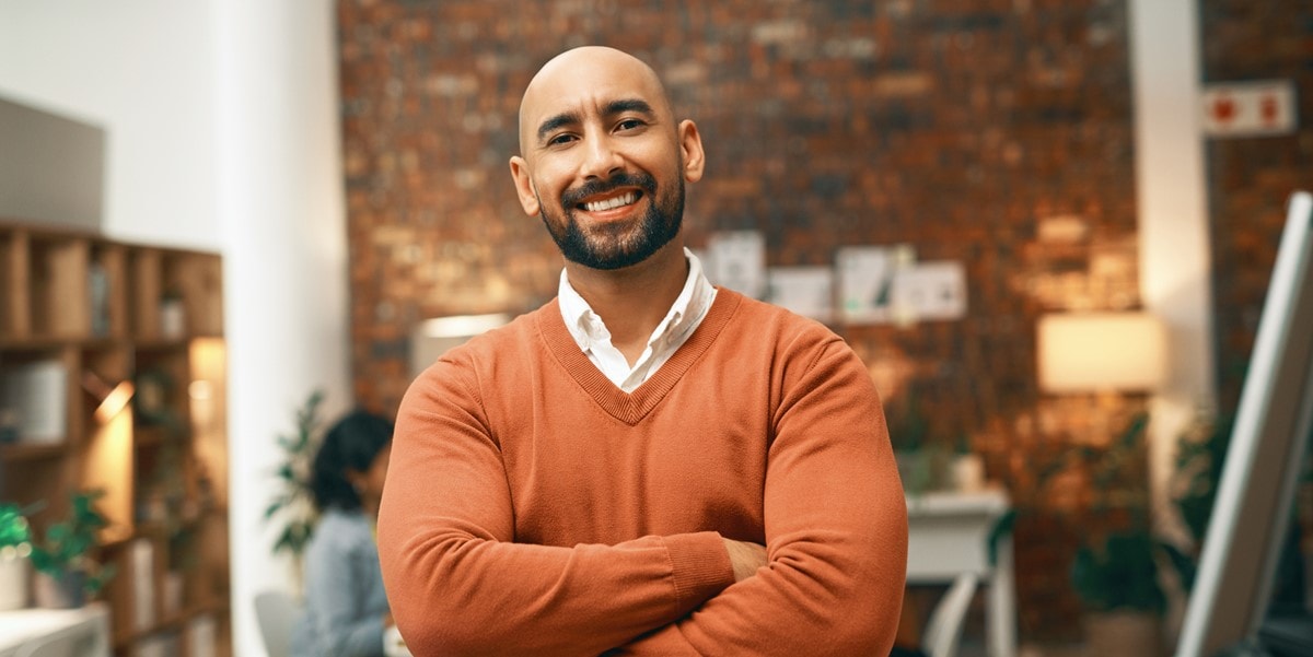 man smiling in the office, arms crossed