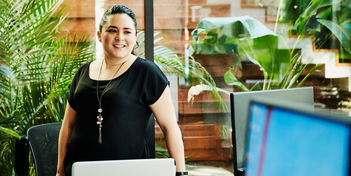 woman standing next to desk in the office