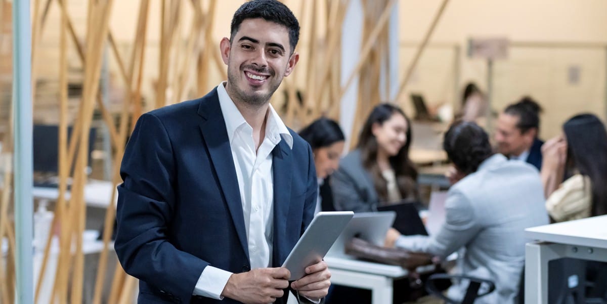 professional man smiling, in the office