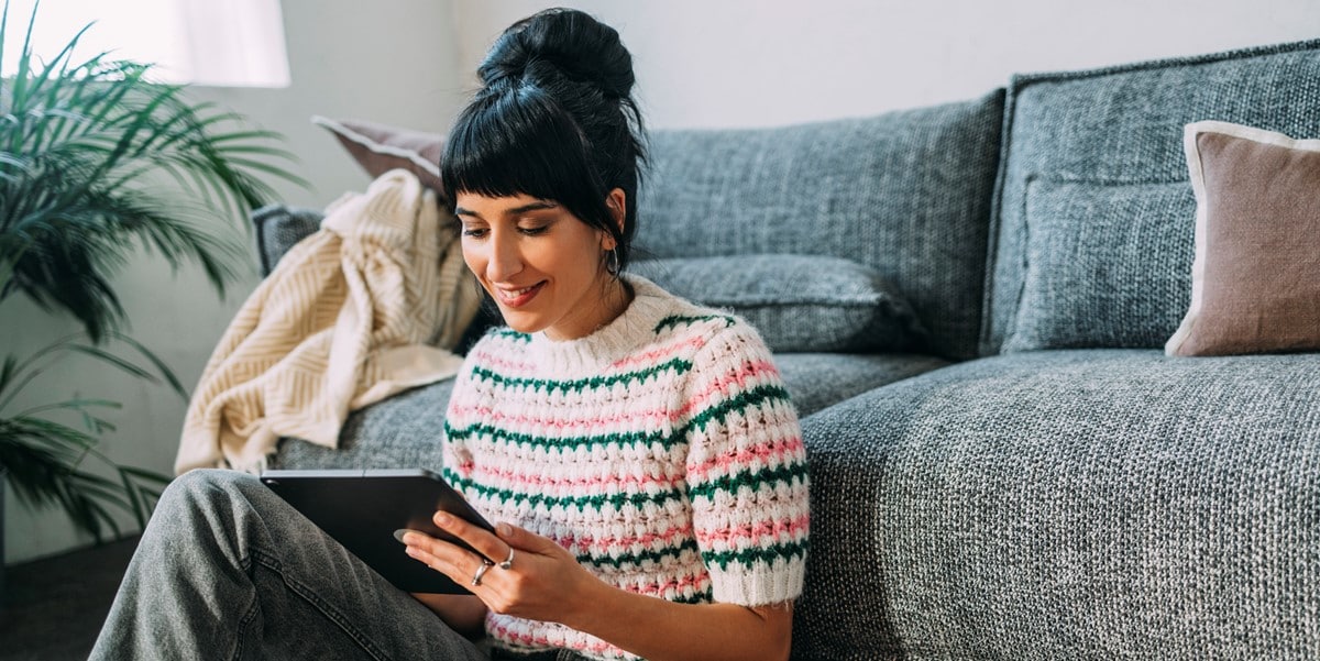 woman working in living room, using tablet
