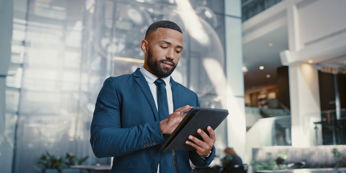 professional man in office, using tablet