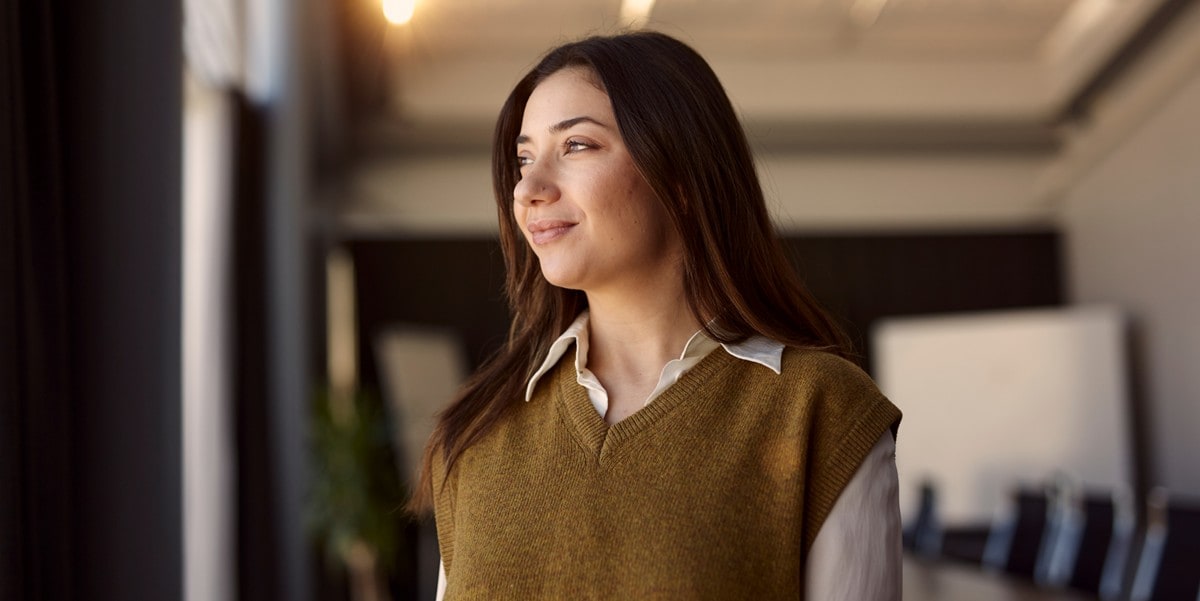 businesswoman smiling looking out window