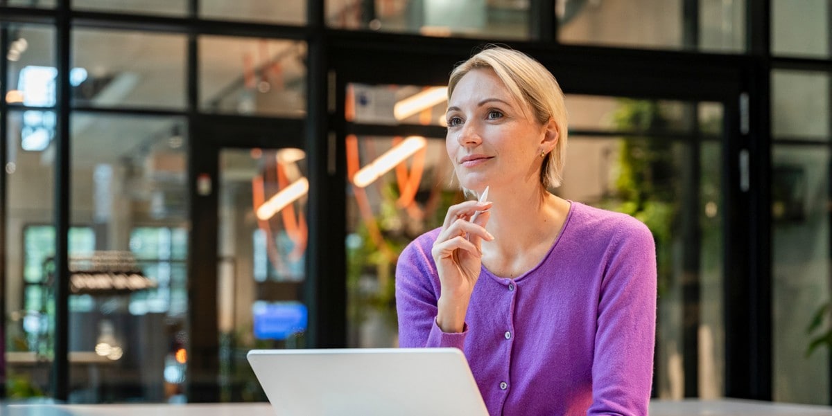 woman in an office sitting at desk with laptop