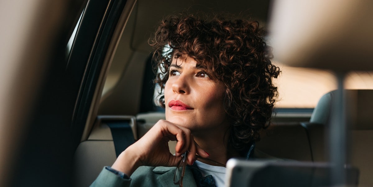woman travelling by car looking out window