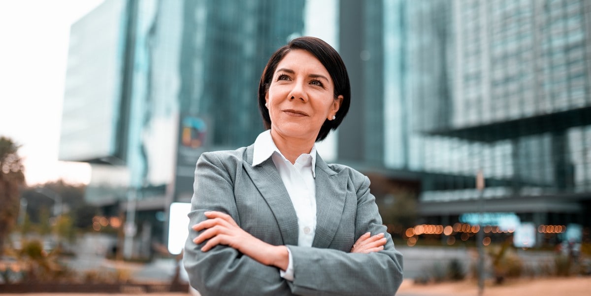 professional woman smiling with arms crossed