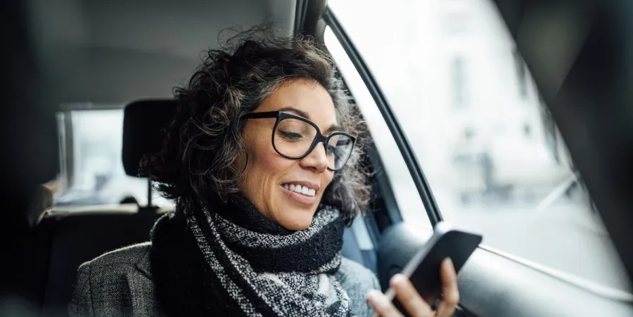 Woman looking at phone and smiling